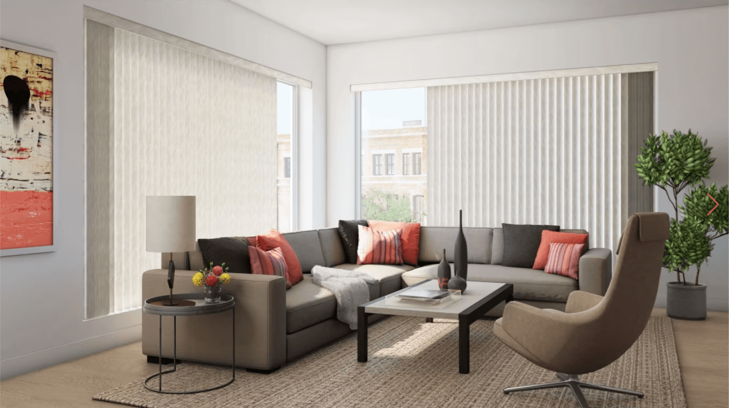 Modern living room with a beige sectional sofa, coral cushions, a glass-top coffee table, and a beige armchair by tall windows with vertical blinds.