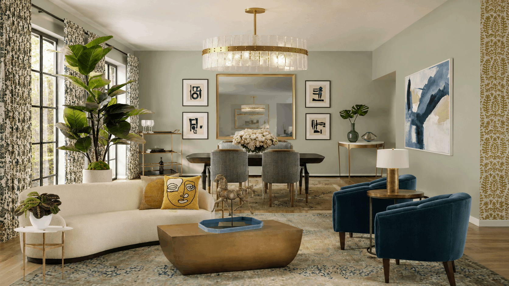 Open living-dining space with a curved cream sofa, yellow pillows, blue chairs, gold coffee table, and a large circular chandelier.