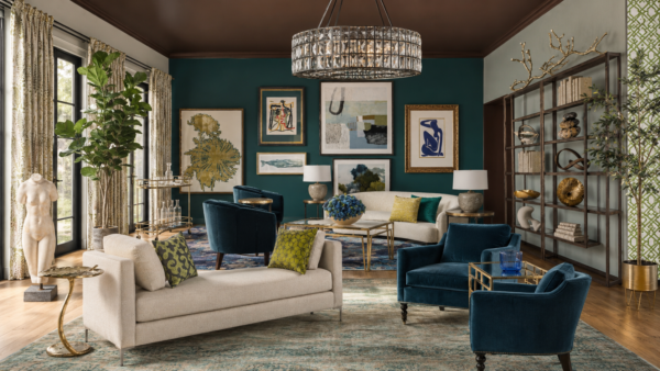 Eclectic living room with teal accent wall, beige sofa, blue velvet chairs, and a gallery wall of art pieces.