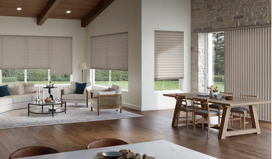 Bright open living and dining area with wooden floors, beige blinds, and a stone feature wall to the right.